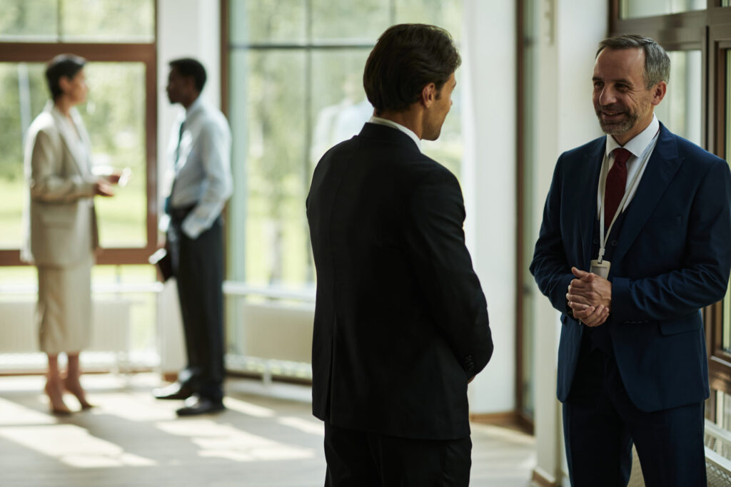 middle aged caucasian man in suit talking with col 2025 09 08 14 02 28 utc scaled.jpg